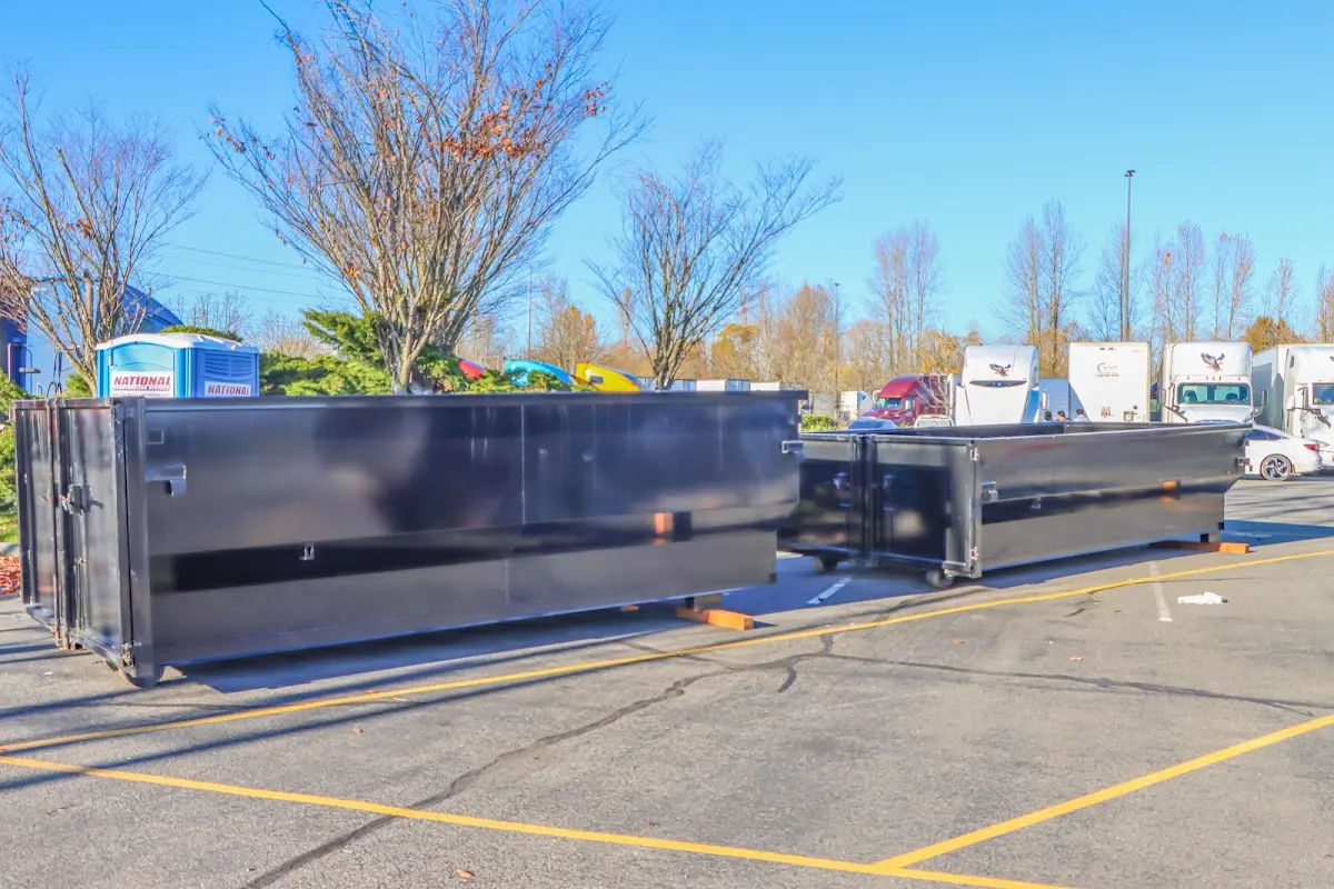 Professional dumpster rental service with roll-off container on residential driveway in Hyattsville